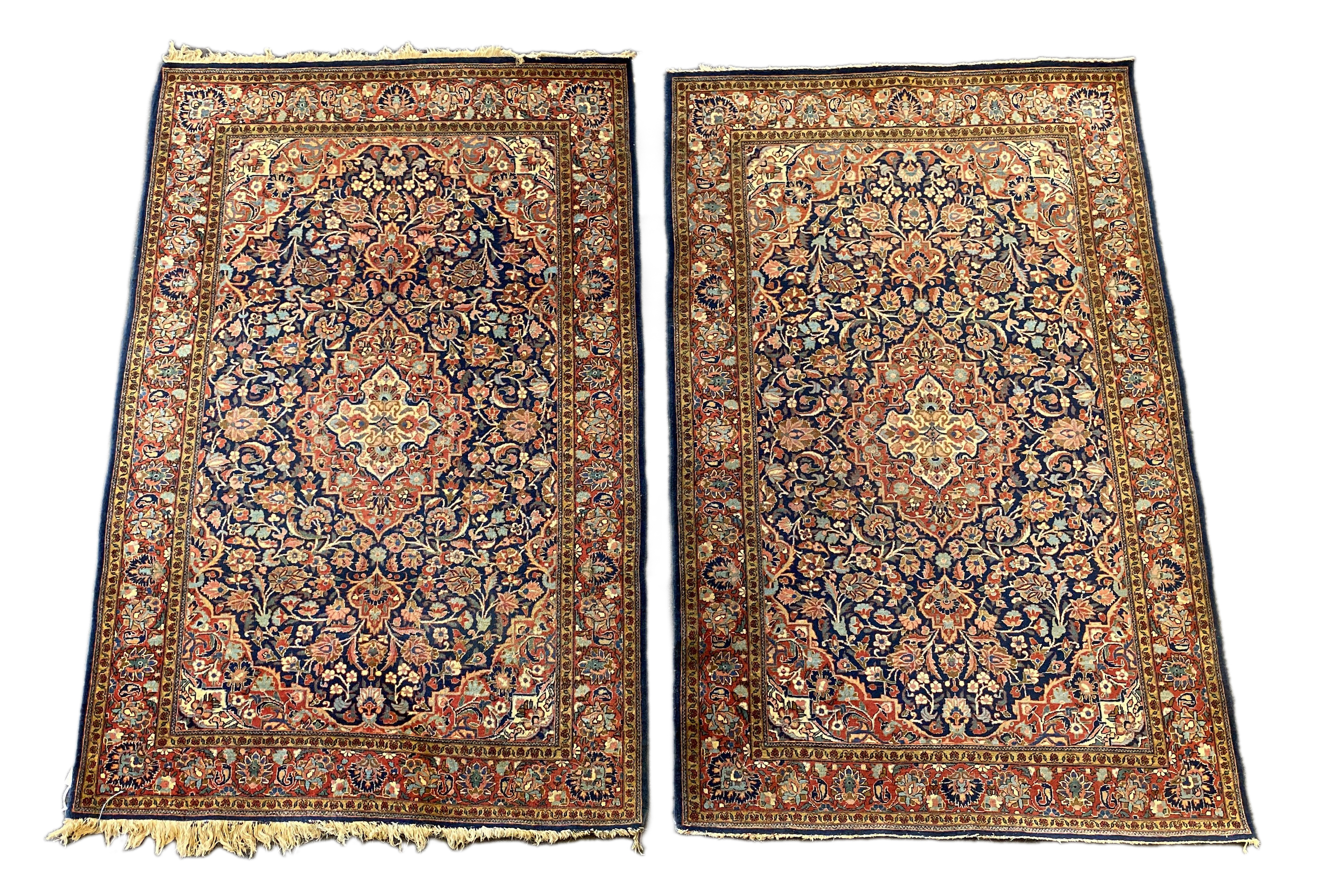 A pair of Kashan blue ground rugs, 213 x 139cm